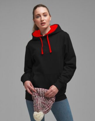 γυναίκα που φοράει δίχρωμο φούτερ με τσέπες και κουκούλα σε χρώμα μαύρο με κόκκινα κορδόνια και κόκκινο εσωτερικό στην κουκούλα